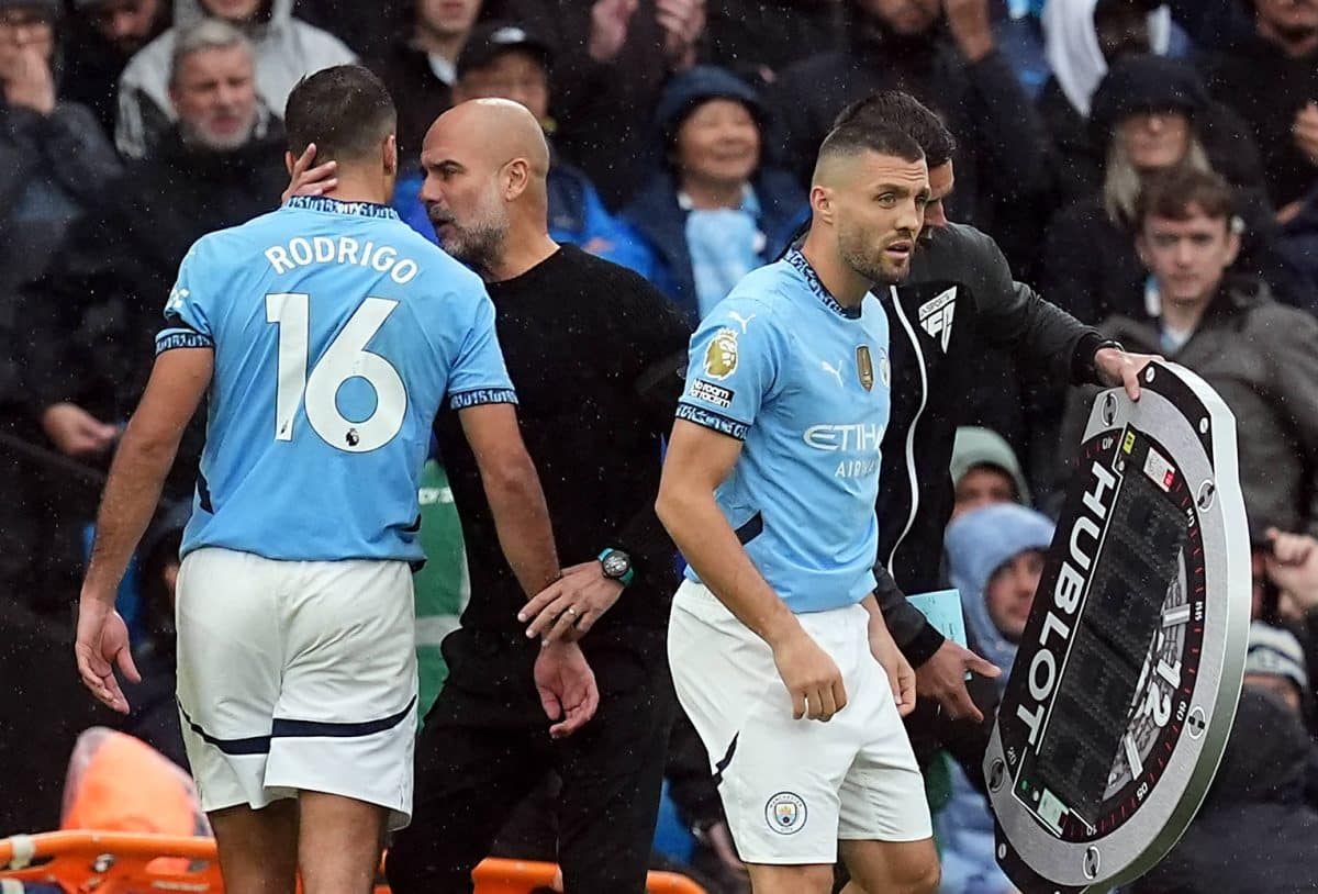Manchester City v Arsenal – Premier League – Etihad Stadium Manchester City manager Pep Guardiola with Rodri (left) duri