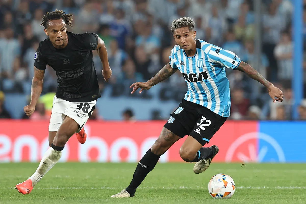 Argentina™s Racing Club midfielder Agustin Almendra (R) controls the ball past Corinthian s Peruvian forward Andre Carri
