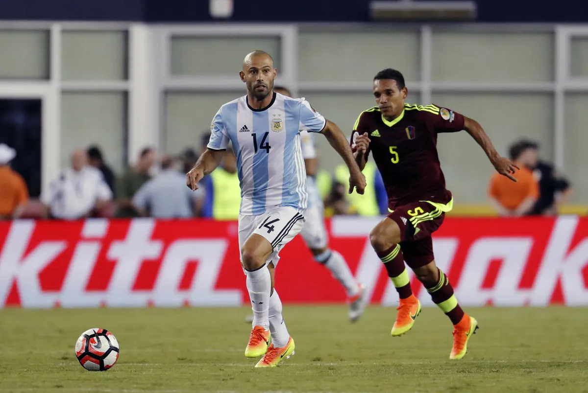 18 June 2016 Argentina midfielder Javier Mascherano 14 looks to push the ball up field chased by
