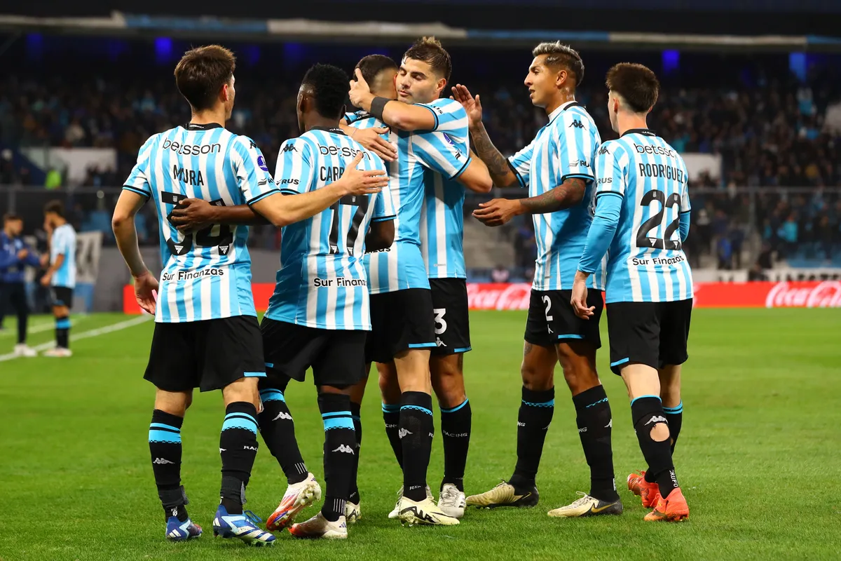 Argentina™s Racing Club s forward Adrian Martinez (C) celebrates with teammates after scoring the team™s seconf goal aga