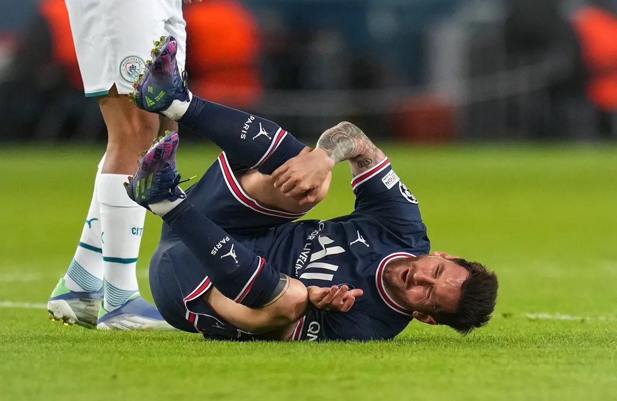 Lionel Messi of PSG rolls around injured during the UEFA Champions League match between Paris Saint Germain and Manchest